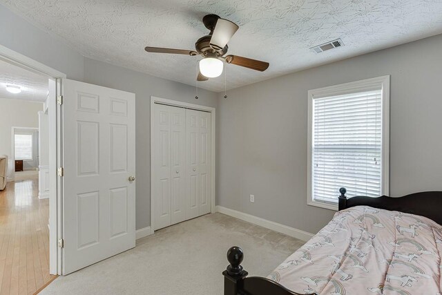 6485 Flowery Way, Flowery Branch, GA 30542 - bedroom with a closet, baseboards, a ceiling fan, and a textured ceiling