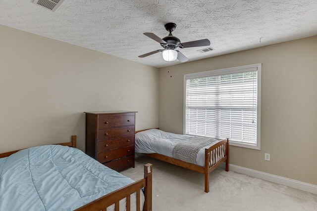 6485 Flowery Way, Flowery Branch, GA 30542 - bedroom featuring light carpet, baseboards, a ceiling fan, and a textured ceiling