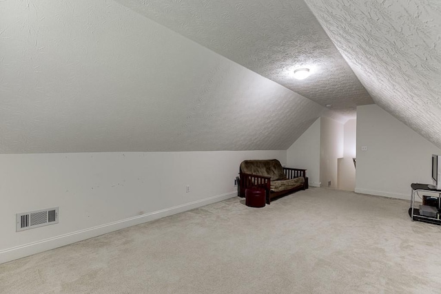 6485 Flowery Way, Flowery Branch, GA 30542 - additional living space featuring a textured ceiling, lofted ceiling, baseboards, and carpet