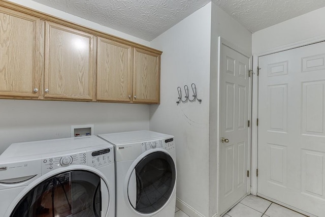 6485 Flowery Way, Flowery Branch, GA 30542 - washroom with cabinet space, separate washer and dryer, light tile patterned flooring, and a textured ceiling