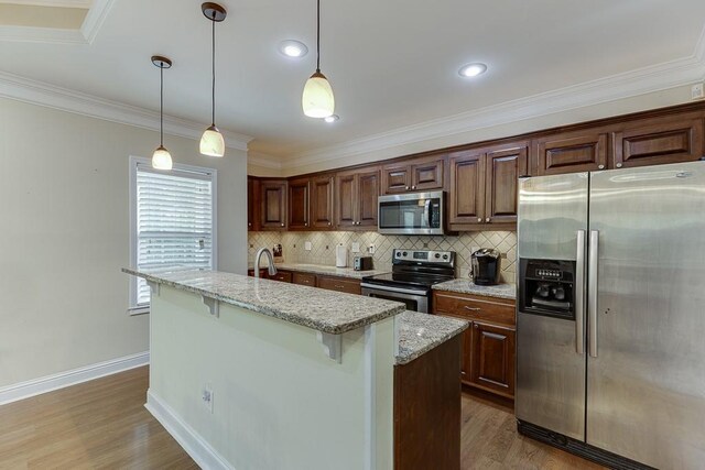 6485 Flowery Way, Flowery Branch, GA 30542 - kitchen featuring appliances with stainless steel finishes, decorative backsplash, light wood-style flooring, baseboards, and light stone counters