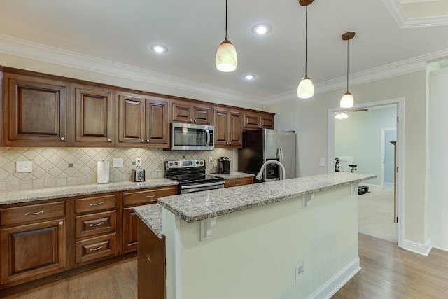 6485 Flowery Way, Flowery Branch, GA 30542 - kitchen with appliances with stainless steel finishes, light stone counters, a center island, pendant lighting, and tasteful backsplash