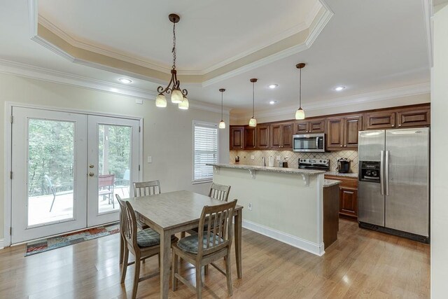 6485 Flowery Way, Flowery Branch, GA 30542 - dining area with a raised ceiling, light wood finished floors, ornamental molding, french doors, and recessed lighting
