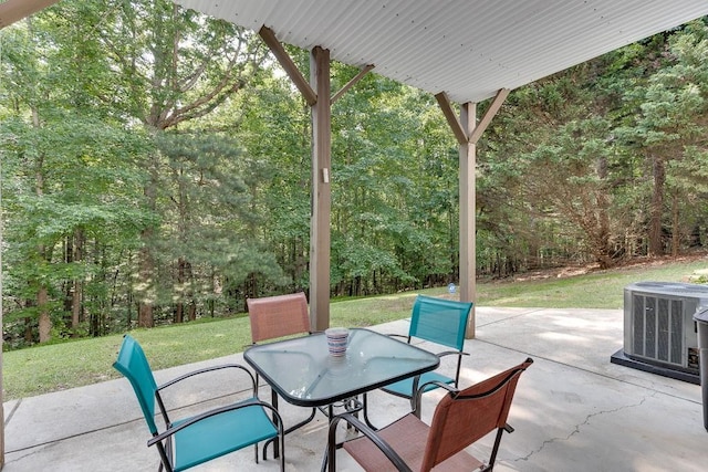 6485 Flowery Way, Flowery Branch, GA 30542 - view of patio with central air condition unit, outdoor dining area, and a wooded view