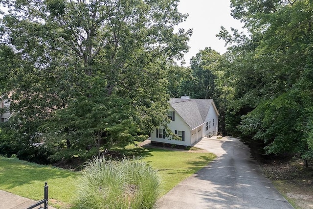 6485 Flowery Way, Flowery Branch, GA 30542 - view of side of home with asphalt driveway, a lawn, and a chimney