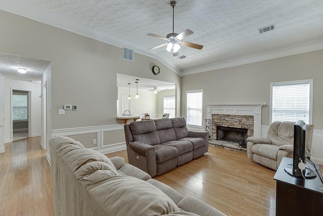 6485 Flowery Way, Flowery Branch, GA 30542 - living area with a textured ceiling, a ceiling fan, crown molding, vaulted ceiling, and plenty of natural light