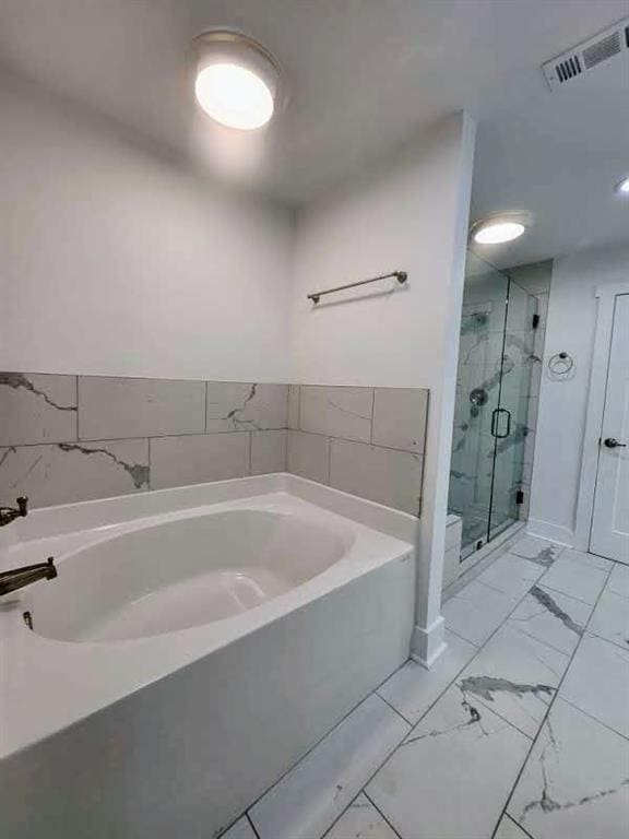 bathroom with separate shower and tub