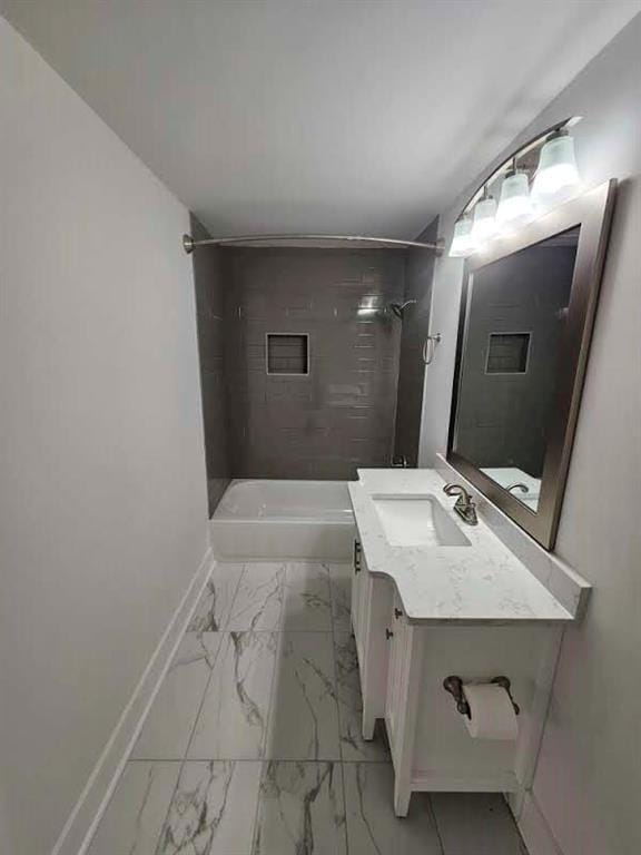 bathroom with vanity and tiled shower / bath combo