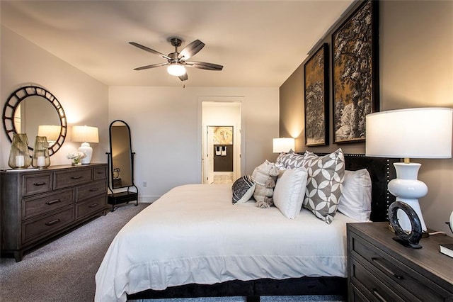 bedroom with ceiling fan, dark carpet, and ensuite bath