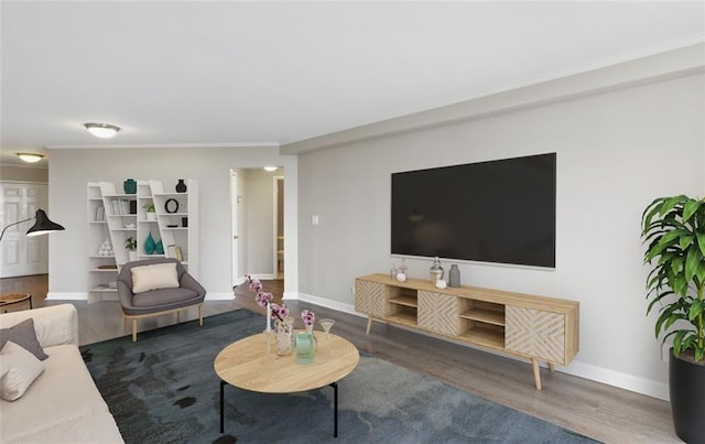 living room with crown molding and dark wood-type flooring