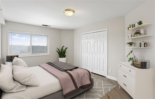 bedroom featuring a closet and dark hardwood / wood-style floors