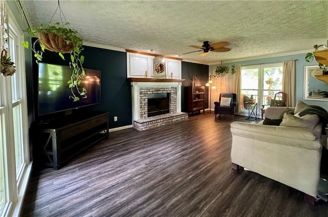 4114 Falcon Shores Ct NW, Acworth, GA 30101 - living room featuring ornamental molding, dark wood-style floors, a fireplace, ceiling fan, and a textured ceiling