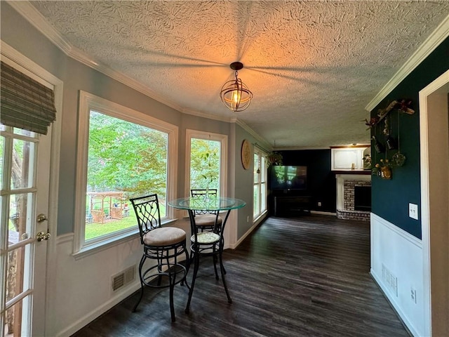 4114 Falcon Shores Ct NW, Acworth, GA 30101 - dining area featuring a textured ceiling, dark wood-style floors, plenty of natural light, and ornamental molding