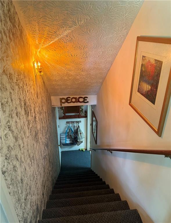 4114 Falcon Shores Ct NW, Acworth, GA 30101 - stairway with carpet flooring and a textured ceiling