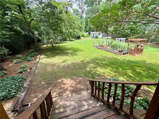 4114 Falcon Shores Ct NW, Acworth, GA 30101 - view of green lawn with a vegetable garden and a wooden deck