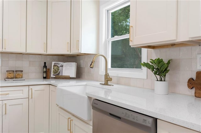 1980 Oakdale Ct SE, Smyrna, GA 30082 - kitchen with stainless steel dishwasher, backsplash, white cabinets, light stone counters, and a sink