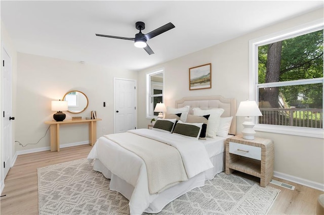 1980 Oakdale Ct SE, Smyrna, GA 30082 - bedroom with light wood finished floors, baseboards, and a ceiling fan
