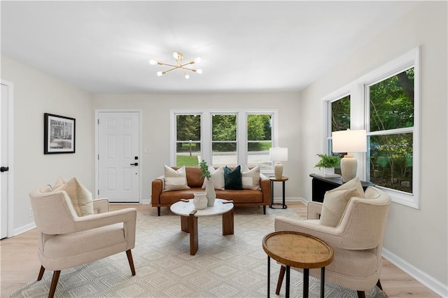1980 Oakdale Ct SE, Smyrna, GA 30082 - living area featuring healthy amount of natural light, light wood-type flooring, a chandelier, and baseboards