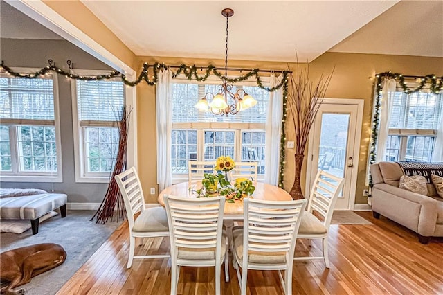 dining room featuring hardwood / wood-style floors, a notable chandelier, and a wealth of natural light