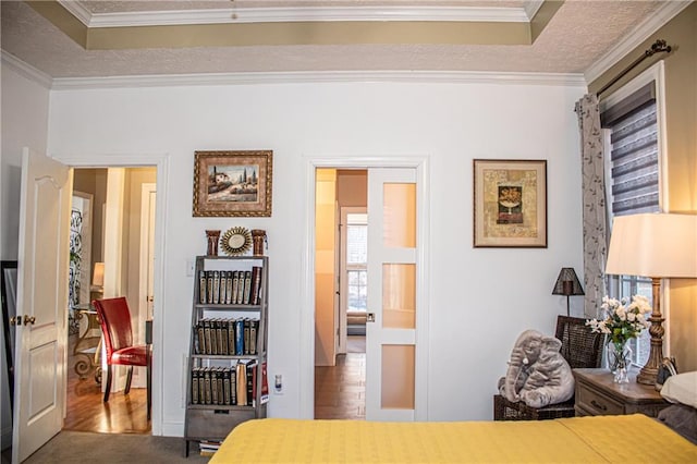 bedroom with a raised ceiling, carpet, and ornamental molding