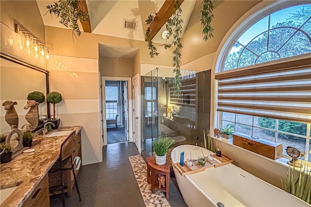 bathroom with a wealth of natural light, vanity, independent shower and bath, and high vaulted ceiling