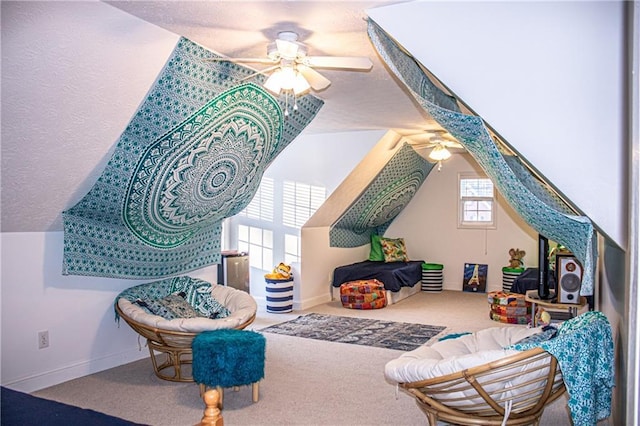 interior space featuring carpet, ceiling fan, and lofted ceiling