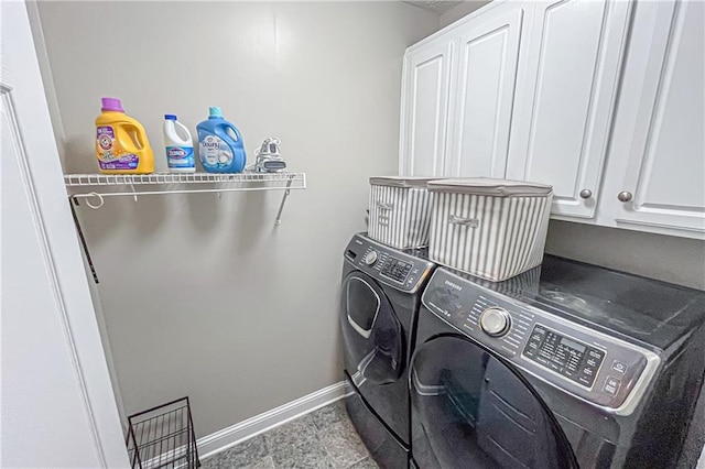 laundry room with cabinets and washing machine and dryer