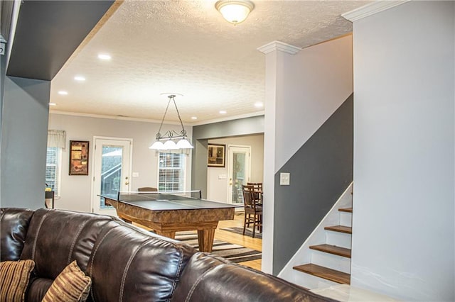 interior space featuring crown molding, plenty of natural light, and a textured ceiling