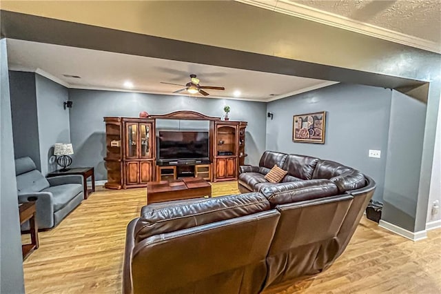 living room featuring a textured ceiling, light hardwood / wood-style flooring, ceiling fan, and ornamental molding