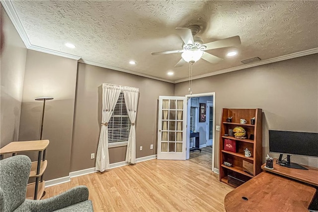 office area with french doors, crown molding, ceiling fan, light wood-type flooring, and a textured ceiling