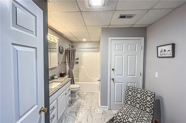 full bathroom featuring toilet, vanity, shower / tub combo with curtain, and a drop ceiling