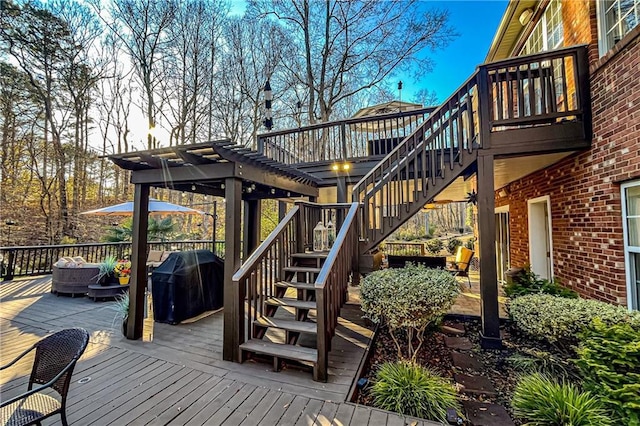 wooden terrace featuring a grill