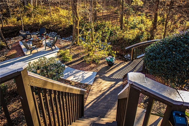 wooden terrace featuring a fire pit