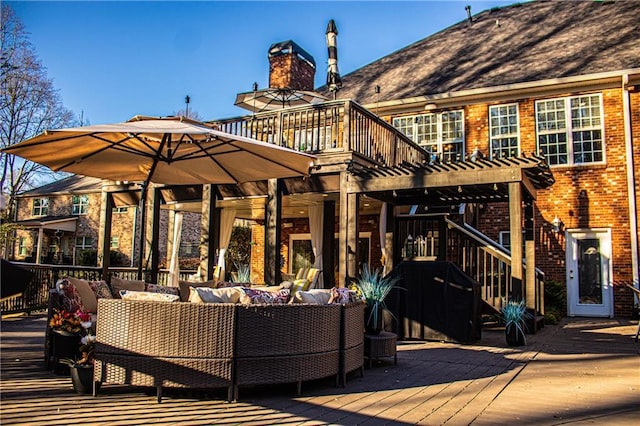 wooden terrace with an outdoor hangout area and a pergola