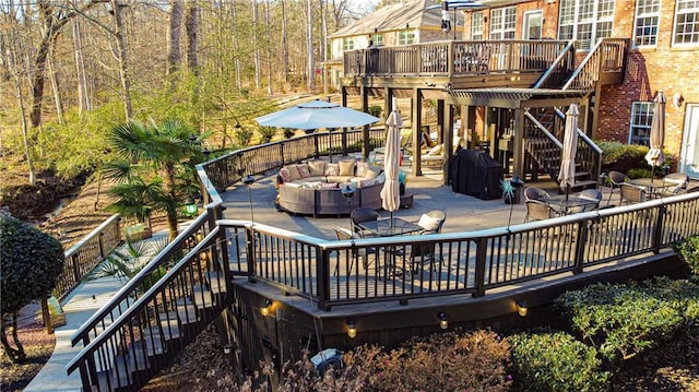 wooden terrace with outdoor lounge area and a patio