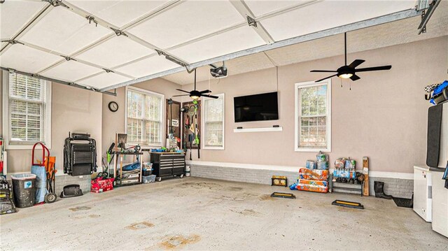 garage with ceiling fan and a garage door opener