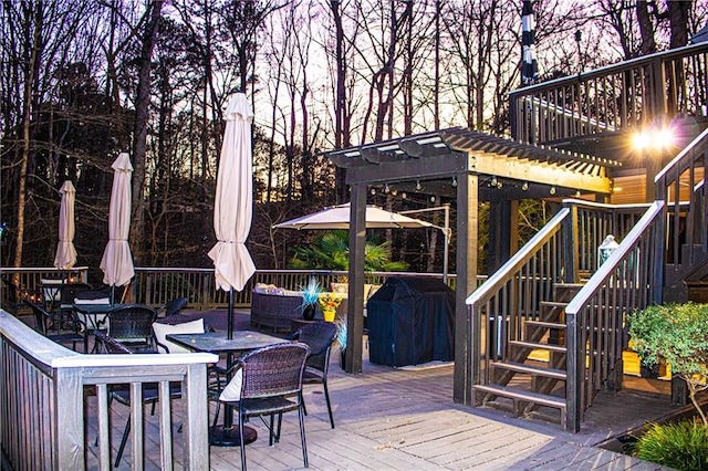 wooden terrace with an outdoor living space and a grill