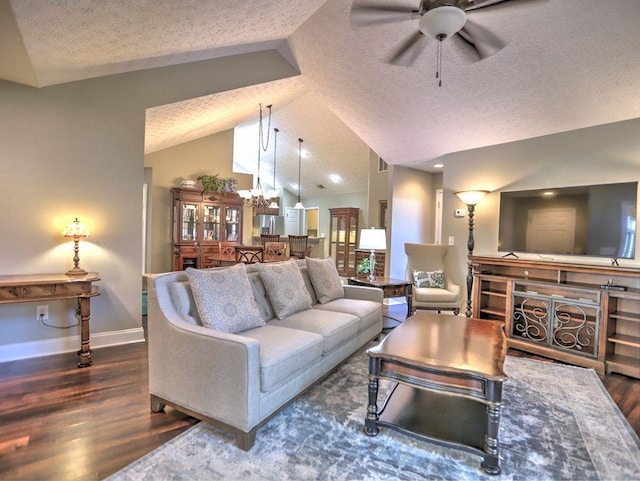 living area with wood finished floors, ceiling fan with notable chandelier, high vaulted ceiling, a textured ceiling, and baseboards