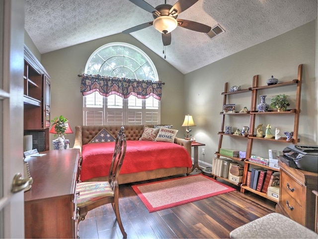 bedroom featuring vaulted ceiling, a textured ceiling, visible vents, and wood finished floors