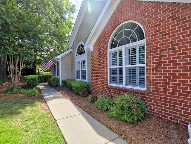 view of exterior entry with brick siding