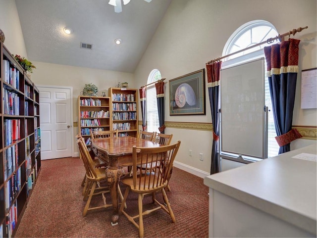 office space with high vaulted ceiling, visible vents, baseboards, and carpet floors