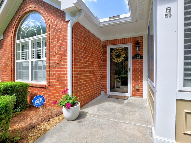 property entrance featuring brick siding