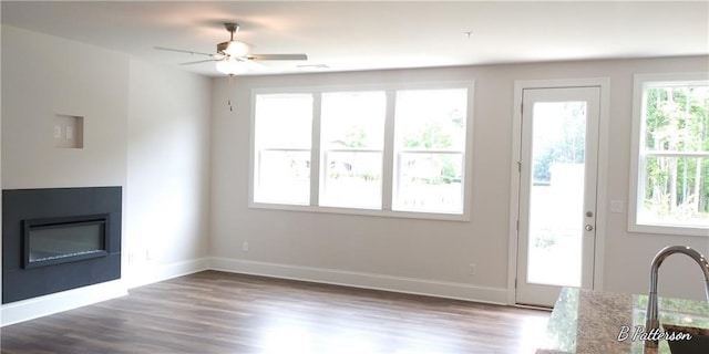 1059 Crest Mill Dr, Marietta, GA 30008 - unfurnished living room featuring a glass covered fireplace, dark wood-style flooring, and a ceiling fan
