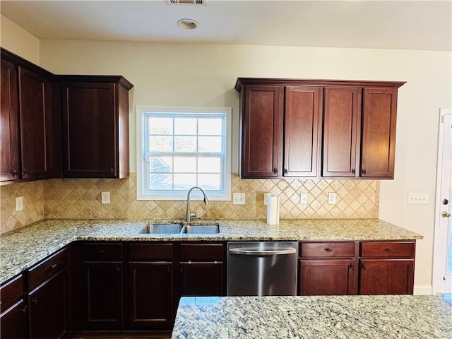 kitchen featuring sink, decorative backsplash, light stone countertops, and dishwasher