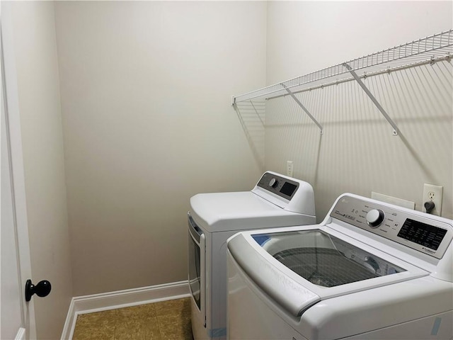 laundry room with washing machine and clothes dryer