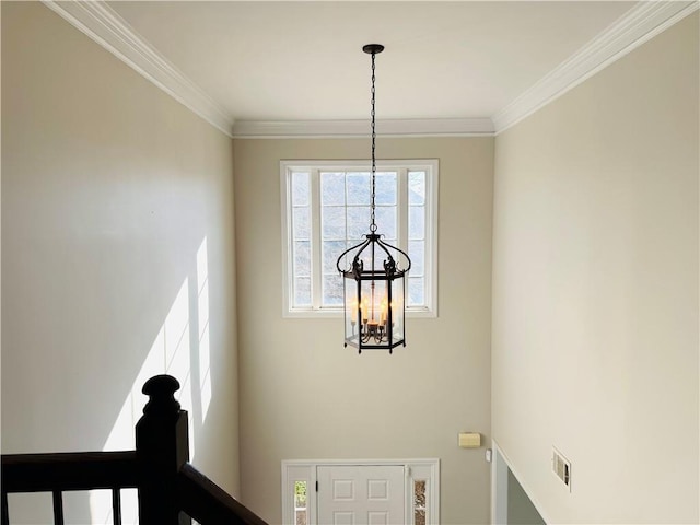 stairs featuring crown molding and a notable chandelier