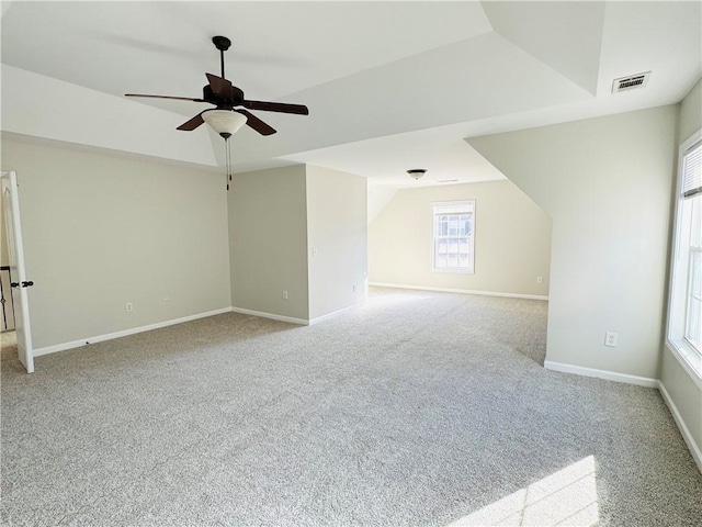 additional living space featuring light carpet, lofted ceiling, and ceiling fan