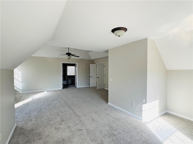 bonus room featuring lofted ceiling and light colored carpet