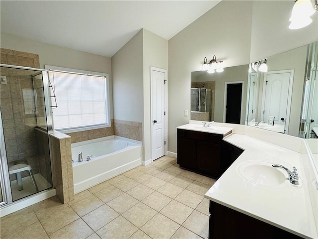 bathroom featuring tile patterned flooring, vaulted ceiling, separate shower and tub, and vanity