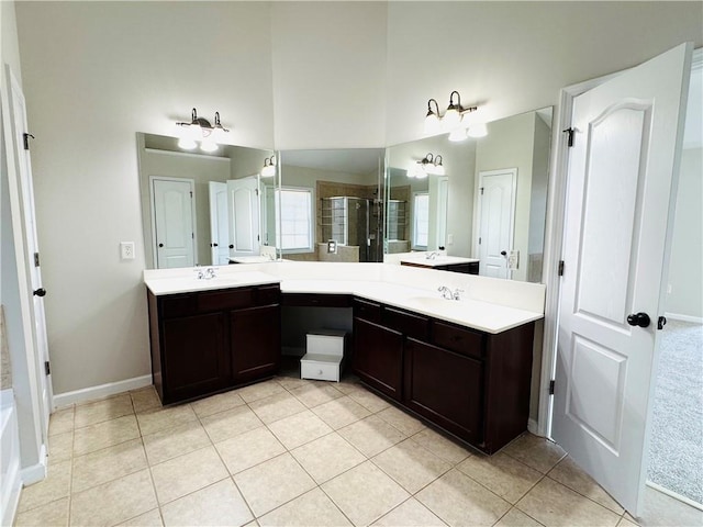 bathroom featuring walk in shower, a towering ceiling, vanity, and tile patterned flooring